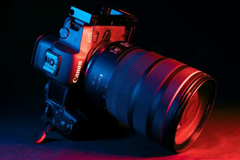 black Canon dslr camera on red textile