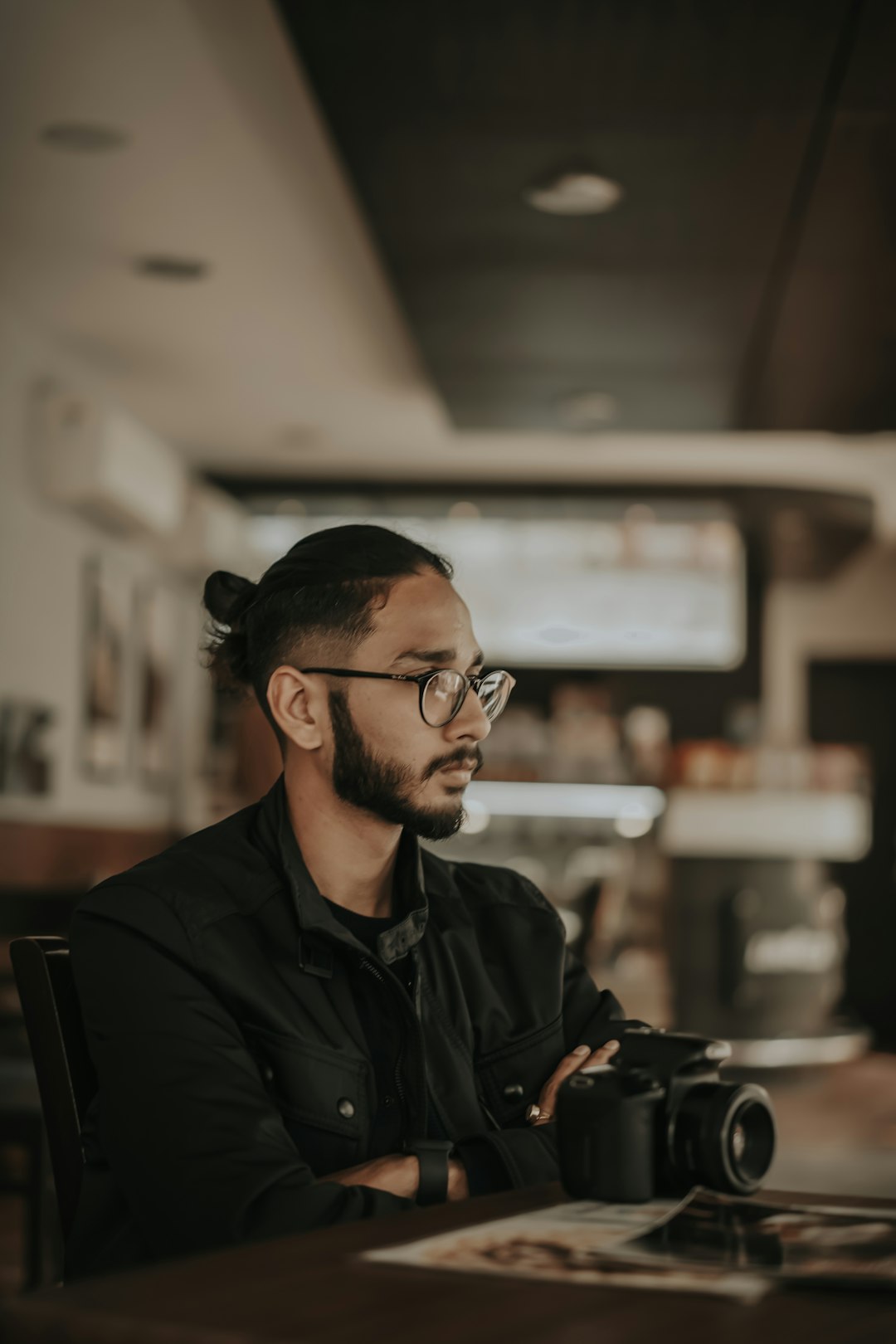 man in black leather jacket wearing black framed eyeglasses