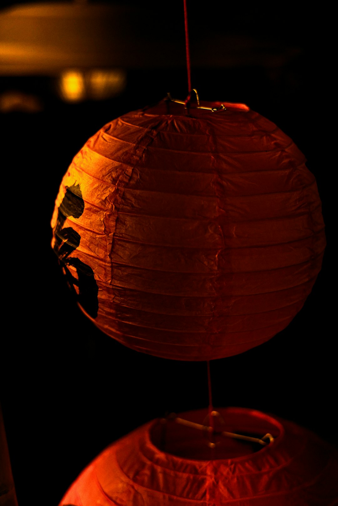 a couple of red lanterns hanging from a ceiling