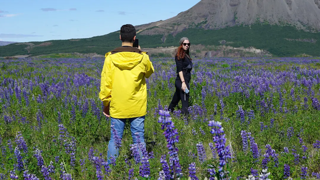 person holding camera looking at camera settings