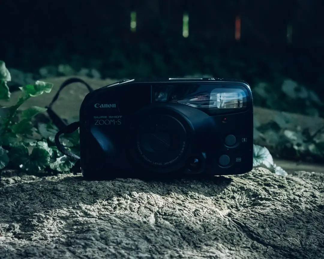 a black camera sitting on top of a rock