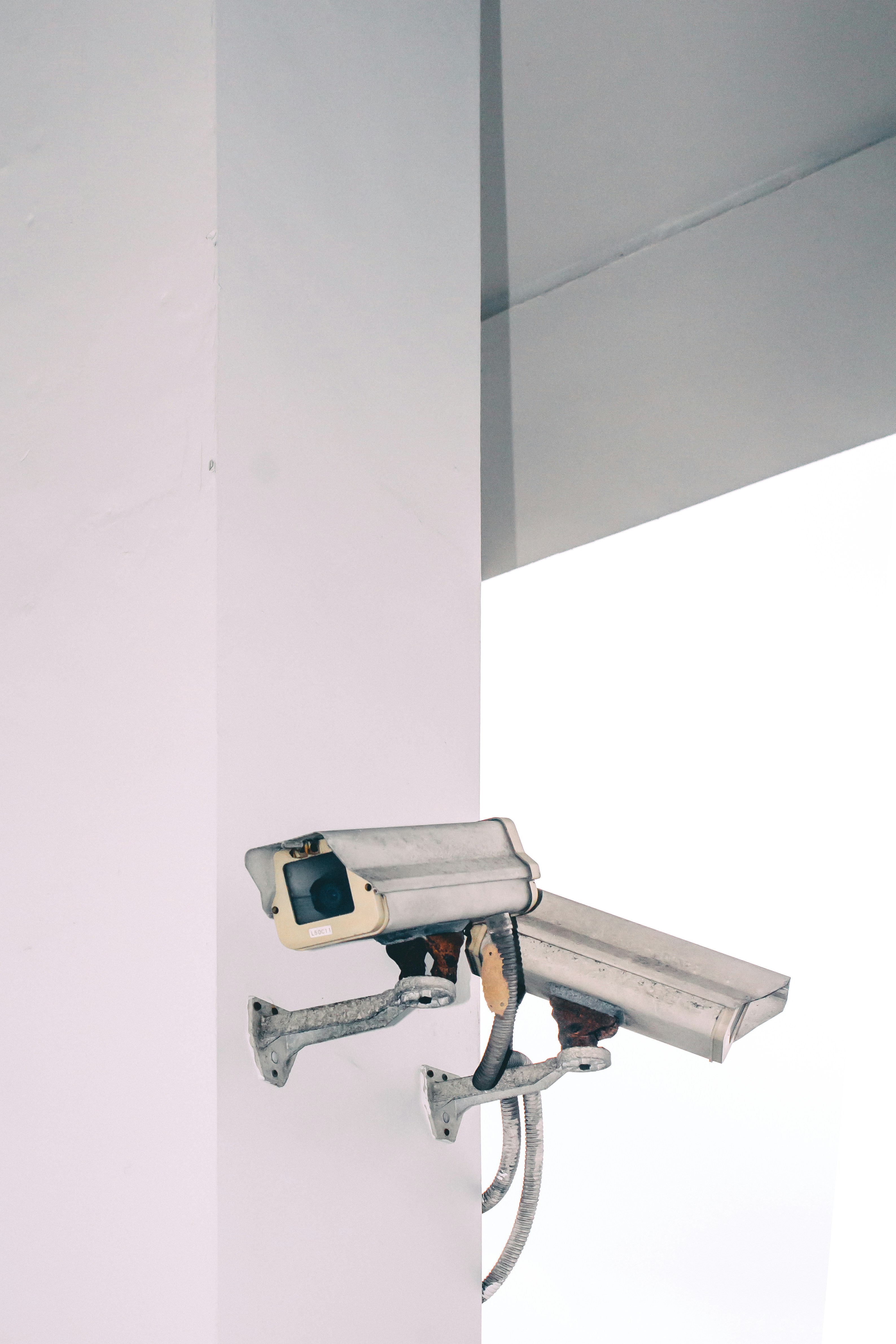two bullet security camera attached on wall
