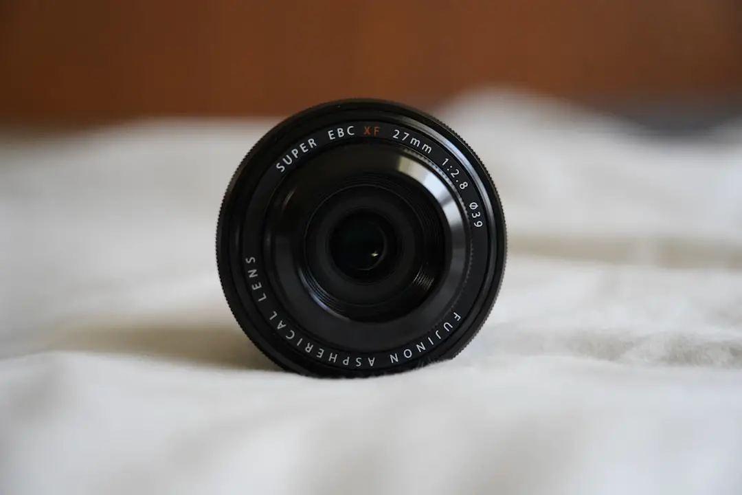 a close up of a camera lens on a bed