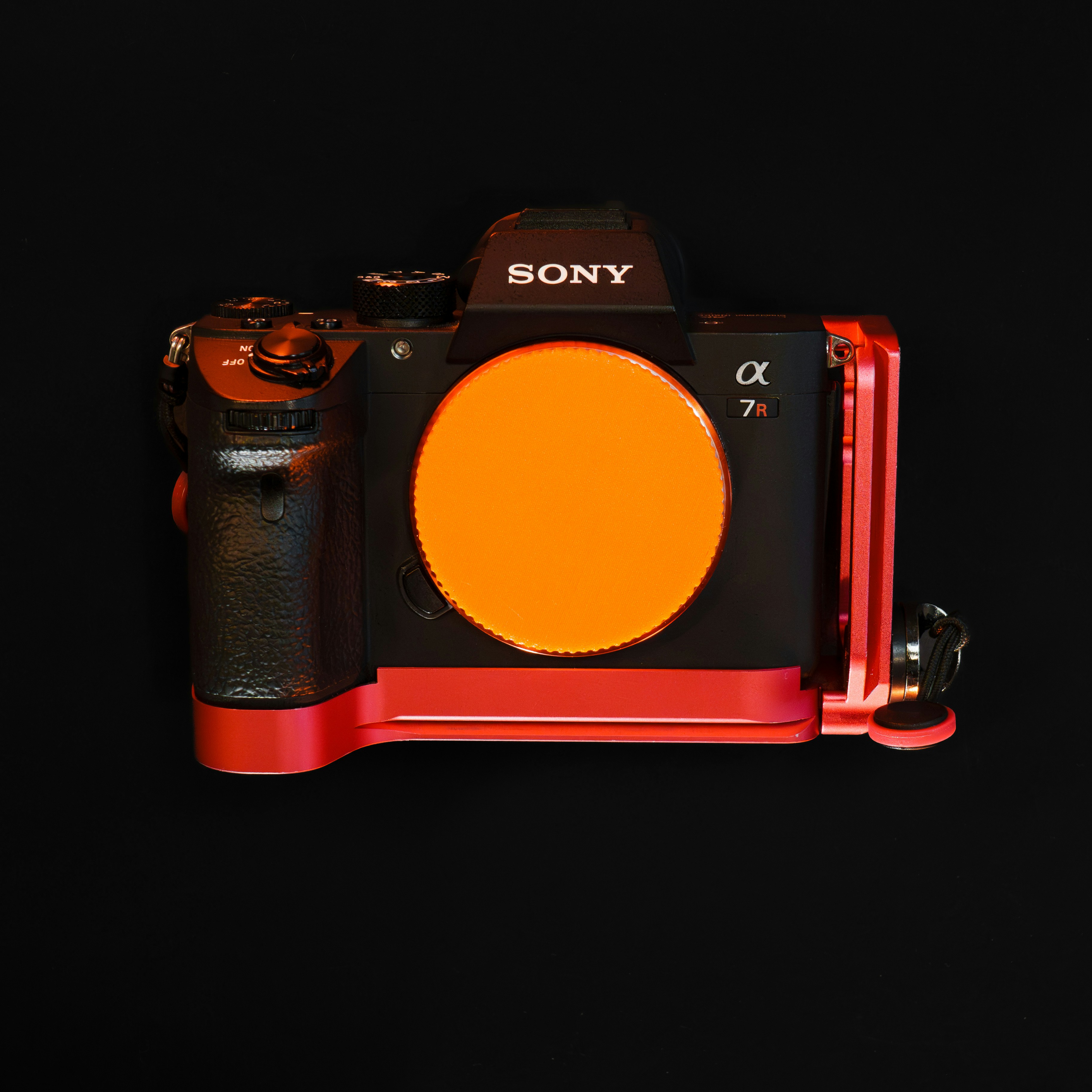 A red and black camera on a black background